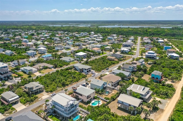 aerial view of residential area featuring a large body of water and a pool