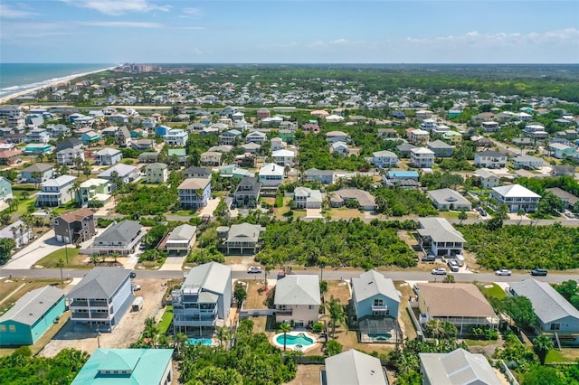 aerial perspective of suburban area featuring a large body of water and a pool area