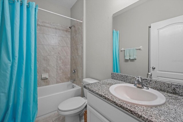 full bathroom featuring shower / bathtub combination with curtain, vanity, and toilet