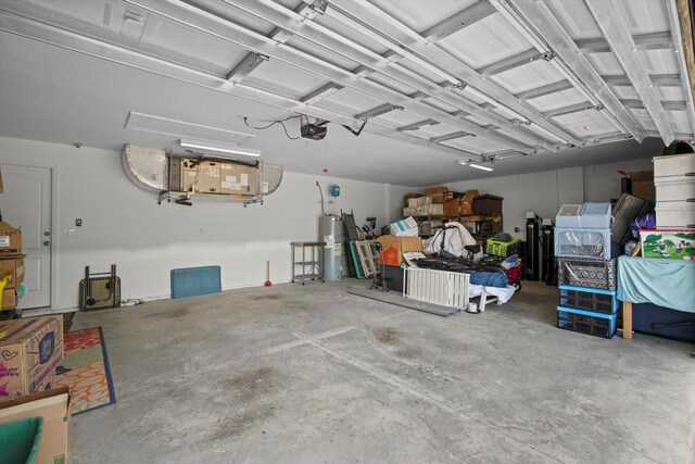 garage featuring water heater and a garage door opener