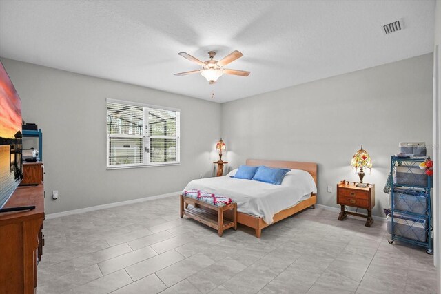 bedroom featuring baseboards and ceiling fan