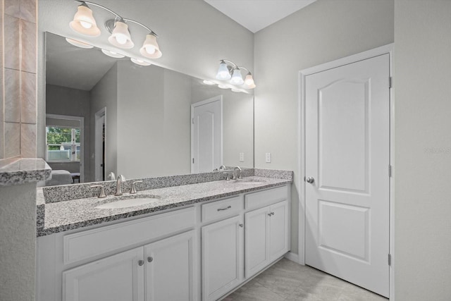 bathroom featuring double vanity and ensuite bathroom