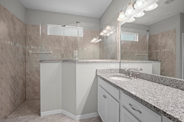 bathroom with a walk in shower and vanity