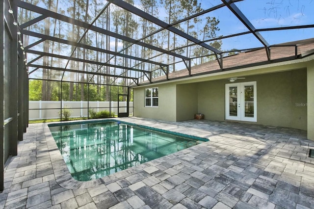 view of pool featuring french doors, a patio area, a lanai, ceiling fan, and fence