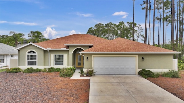 ranch-style home featuring stucco siding, an attached garage, driveway, and a shingled roof