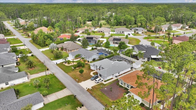 aerial overview of property's location with a forest and nearby suburban area