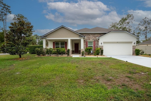 craftsman house featuring driveway, an attached garage, a front yard, and stone siding