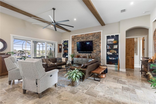440 Lambert Ave, Flagler Beach, FL 32136 - living room with arched walkways, stone tile floors, a ceiling fan, beam ceiling, and built in features