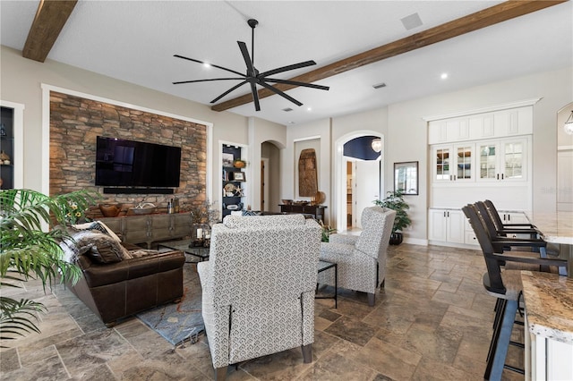440 Lambert Ave, Flagler Beach, FL 32136 - living area with arched walkways, a ceiling fan, beamed ceiling, and stone tile flooring