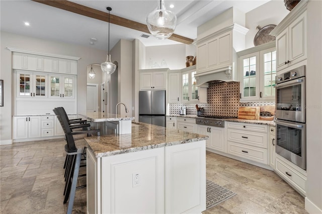 440 Lambert Ave, Flagler Beach, FL 32136 - kitchen featuring stainless steel appliances, beamed ceiling, backsplash, a kitchen bar, and stone tile flooring