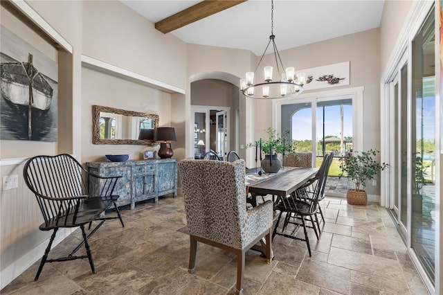 440 Lambert Ave, Flagler Beach, FL 32136 - dining area with stone tile flooring, a chandelier, arched walkways, beamed ceiling, and a towering ceiling