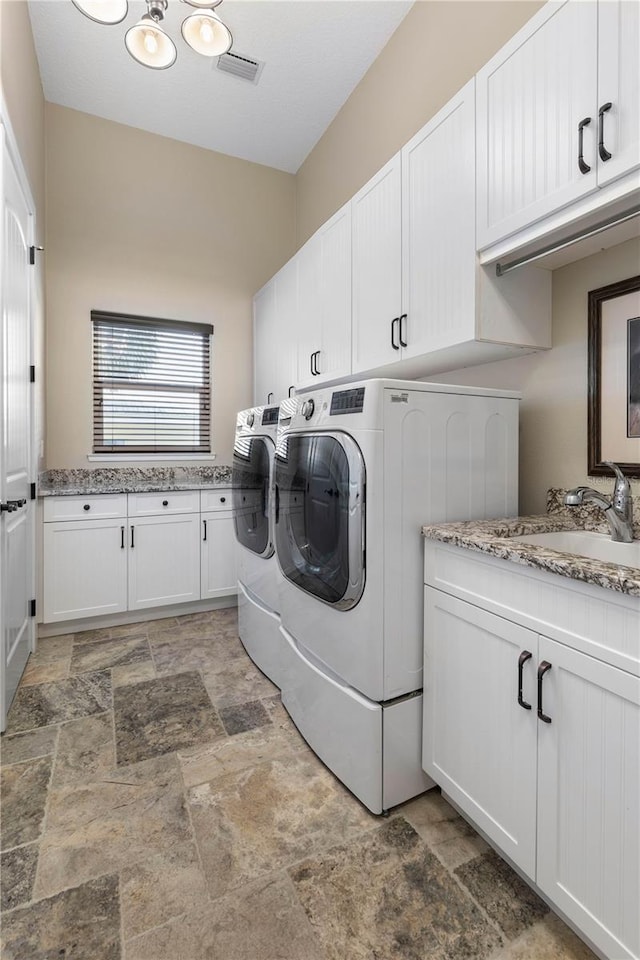 440 Lambert Ave, Flagler Beach, FL 32136 - washroom with independent washer and dryer, stone finish floors, and cabinet space
