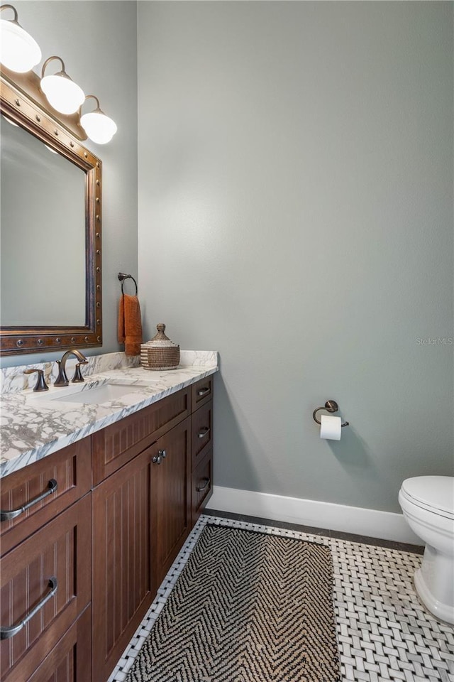 440 Lambert Ave, Flagler Beach, FL 32136 - bathroom featuring baseboards, vanity, and toilet