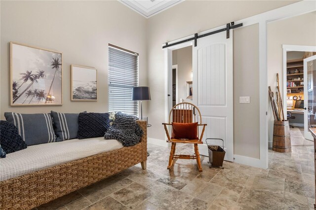 440 Lambert Ave, Flagler Beach, FL 32136 - living room featuring a barn door, stone finish flooring, baseboards, ornamental molding, and a high ceiling