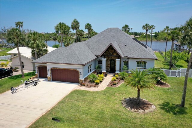 440 Lambert Ave, Flagler Beach, FL 32136 - french country style house featuring an attached garage, stucco siding, stone siding, driveway, and roof with shingles