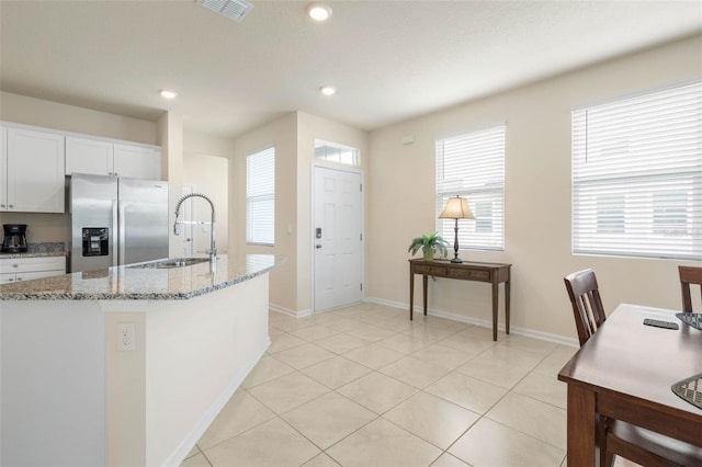 155 Redbud Rd, Palm Coast, FL 32137 - kitchen with stainless steel refrigerator with ice dispenser, a sink, light stone countertops, white cabinetry, and recessed lighting