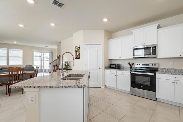 155 Redbud Rd, Palm Coast, FL 32137 - kitchen featuring stainless steel appliances, a sink, a kitchen island with sink, white cabinetry, and recessed lighting