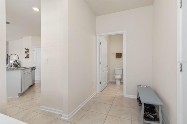 155 Redbud Rd, Palm Coast, FL 32137 - hallway featuring a sink, light tile patterned floors, and baseboards