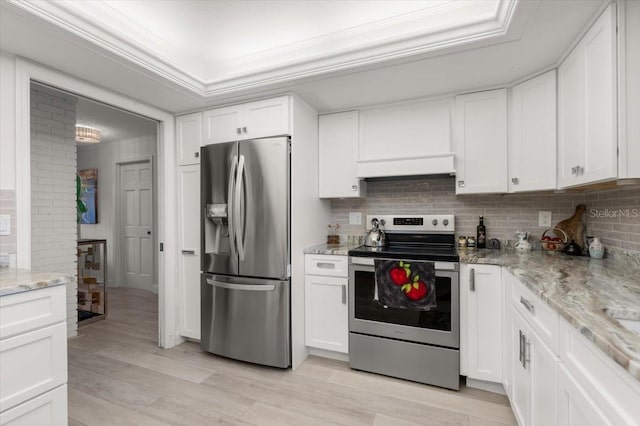 940 Lambert Ave, Flagler Beach, FL 32136 - kitchen featuring stainless steel appliances, white cabinets, crown molding, light wood-type flooring, and tasteful backsplash