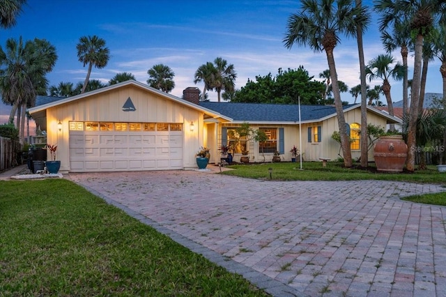 940 Lambert Ave, Flagler Beach, FL 32136 - ranch-style home featuring decorative driveway, a chimney, and an attached garage
