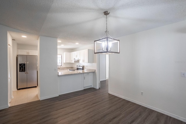 unfurnished dining area with dark wood-style flooring, a sink, baseboards, recessed lighting, and a textured ceiling
