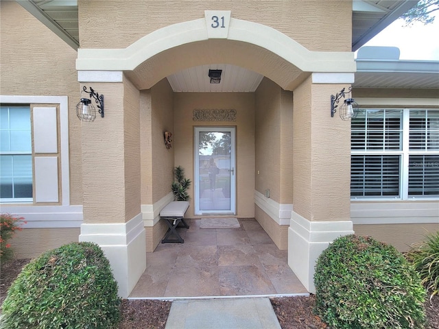 doorway to property with stucco siding