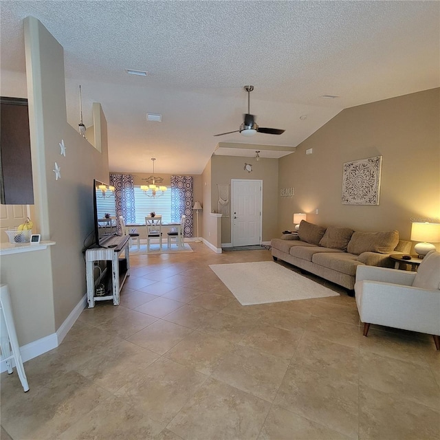 living room with a ceiling fan, lofted ceiling, a chandelier, baseboards, and a textured ceiling
