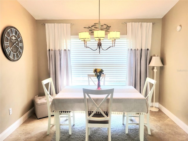 dining room with a chandelier, baseboards, and light tile patterned floors