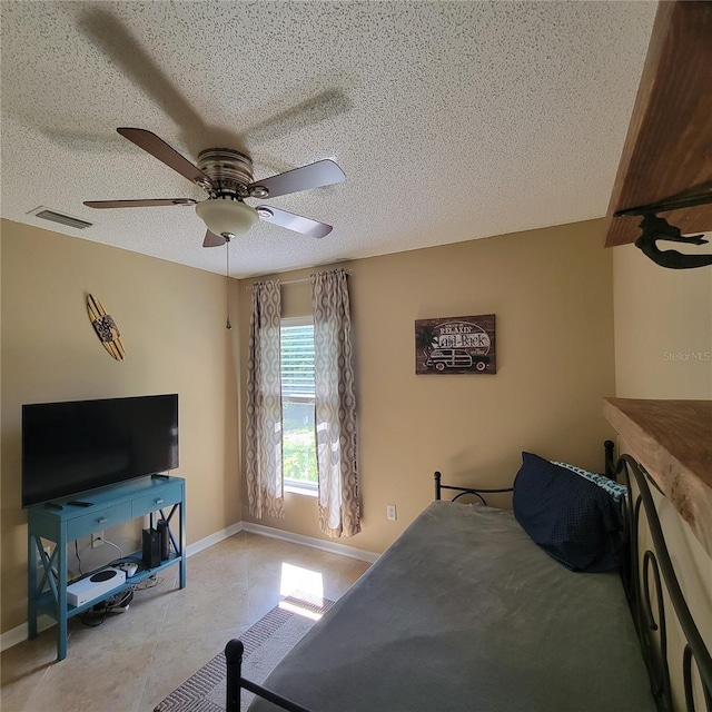 bedroom featuring a textured ceiling, baseboards, and a ceiling fan
