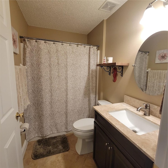 full bath with toilet, a textured ceiling, vanity, and tile patterned flooring