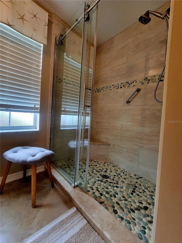 full bath featuring a stall shower and a textured ceiling