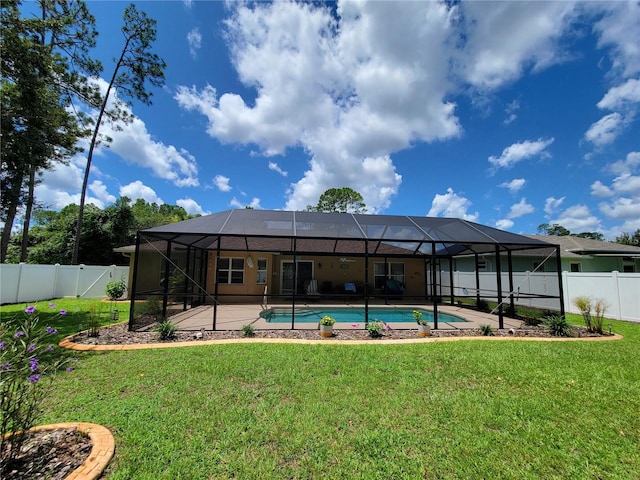 back of property featuring a patio and glass enclosure