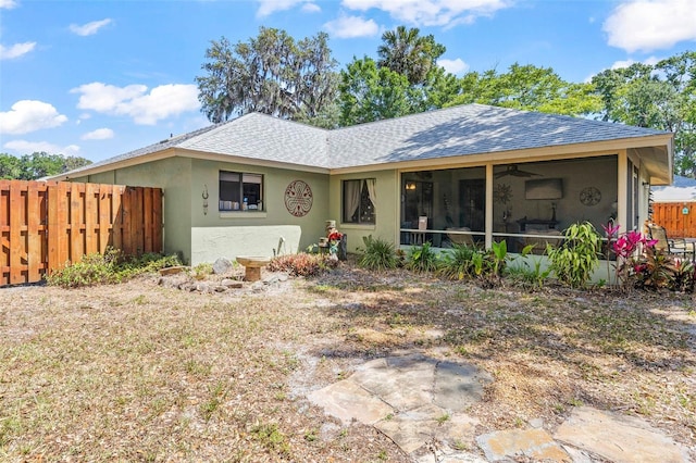 27 Black Hawk Pl, Palm Coast, FL 32137 - back of house with fence, roof with shingles, a sunroom, and ceiling fan