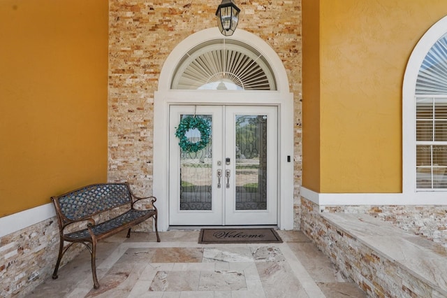 2 Cleveland Ct, Palm Coast, FL 32137 - entrance to property with french doors and stucco siding