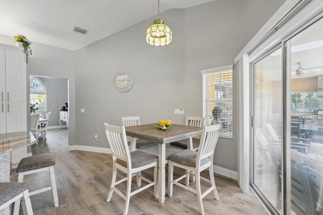 2 Cleveland Ct, Palm Coast, FL 32137 - dining space featuring light wood finished floors, high vaulted ceiling, and a ceiling fan