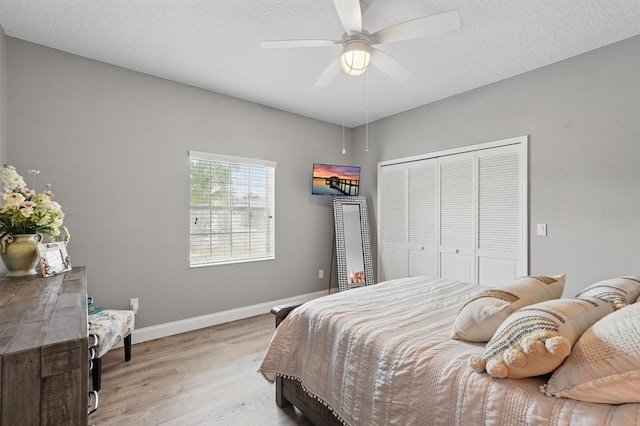 2 Cleveland Ct, Palm Coast, FL 32137 - bedroom with light wood-style floors, a closet, a ceiling fan, and a textured ceiling