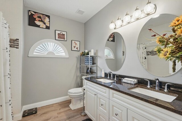 2 Cleveland Ct, Palm Coast, FL 32137 - full bathroom featuring double vanity, healthy amount of natural light, wood finished floors, and curtained shower