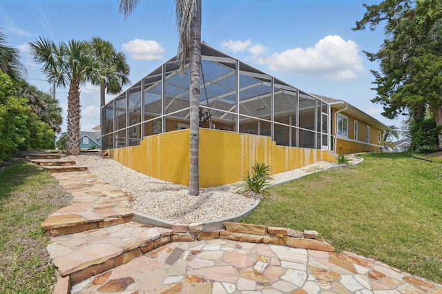2 Cleveland Ct, Palm Coast, FL 32137 - back of house featuring a yard and glass enclosure