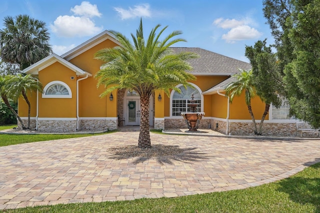 2 Cleveland Ct, Palm Coast, FL 32137 - view of front of home with stucco siding and stone siding