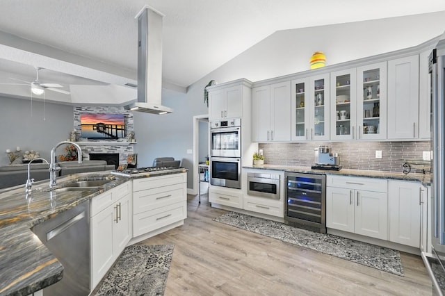 2 Cleveland Ct, Palm Coast, FL 32137 - kitchen featuring beverage cooler, appliances with stainless steel finishes, backsplash, dark stone counters, and a ceiling fan