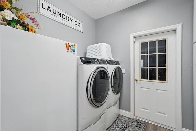 2 Cleveland Ct, Palm Coast, FL 32137 - laundry room with separate washer and dryer, wood finished floors, and a textured ceiling