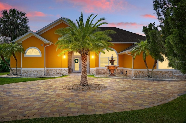 2 Cleveland Ct, Palm Coast, FL 32137 - view of front of house with stone siding and stucco siding