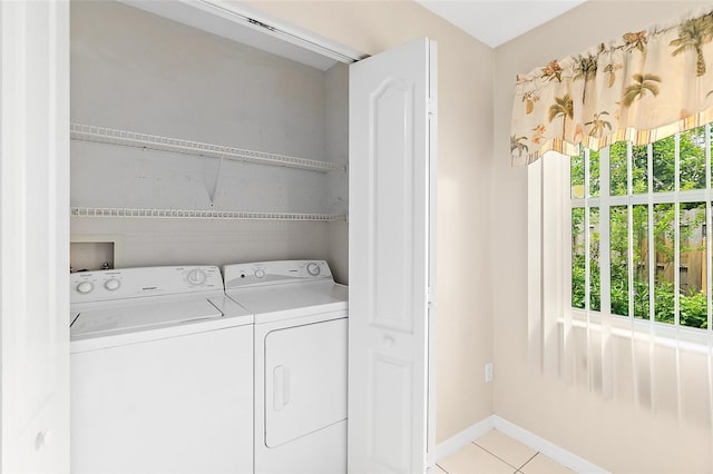 10 Eastwood Dr, Palm Coast, FL 32164 - laundry area with washer and dryer, light tile patterned flooring, and baseboards