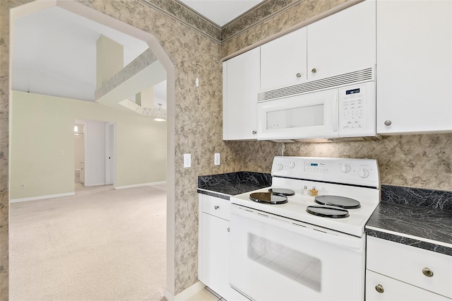 10 Eastwood Dr, Palm Coast, FL 32164 - kitchen featuring white appliances, dark countertops, white cabinetry, baseboards, and tasteful backsplash