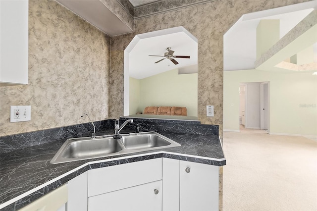 10 Eastwood Dr, Palm Coast, FL 32164 - kitchen with a sink, white cabinetry, carpet, dishwashing machine, and a ceiling fan