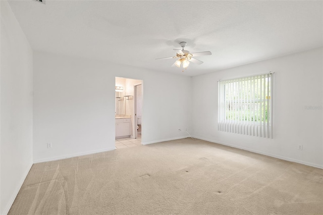 10 Eastwood Dr, Palm Coast, FL 32164 - unfurnished room with light colored carpet, a ceiling fan, and baseboards