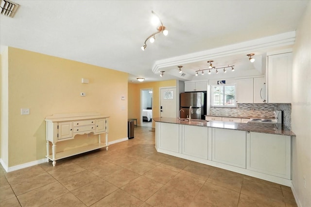 120 Oak Ln, Flagler Beach, FL 32136 - kitchen with freestanding refrigerator, electric stove, a peninsula, light tile patterned floors, and decorative backsplash