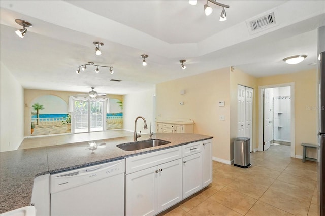 120 Oak Ln, Flagler Beach, FL 32136 - kitchen with a sink, white dishwasher, white cabinetry, dark stone counters, and light tile patterned floors