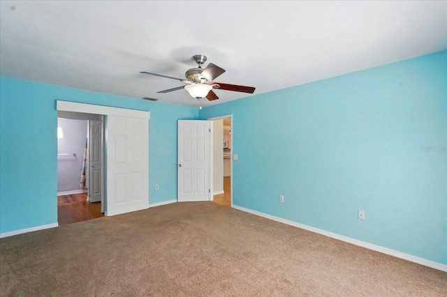 120 Oak Ln, Flagler Beach, FL 32136 - unfurnished bedroom with carpet, baseboards, ceiling fan, and connected bathroom