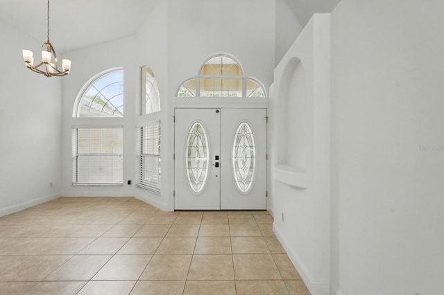 47 Old Oak Dr S, Palm Coast, FL 32137 - entryway with a high ceiling, a chandelier, light tile patterned floors, and baseboards